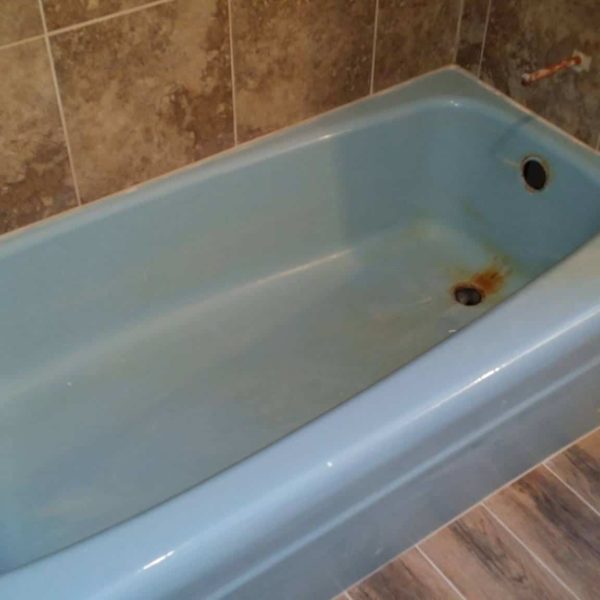 Outdated blue tub in a newly remodeled bathroom in Oswego, IL. -Before refinishing