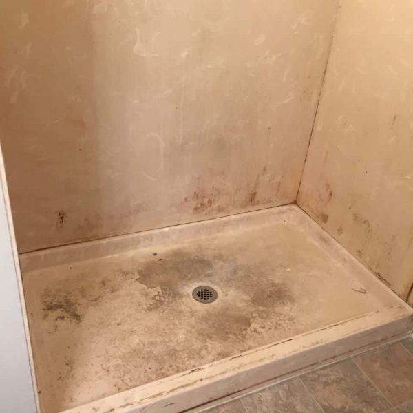 Extremely dirty and degraded shower unit in Lansing, IL. -Before refinishing