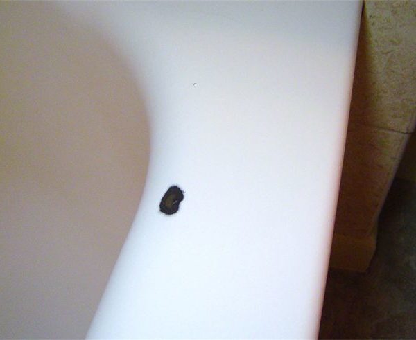 Chip on ledge of porcelain tub in Skokie, IL