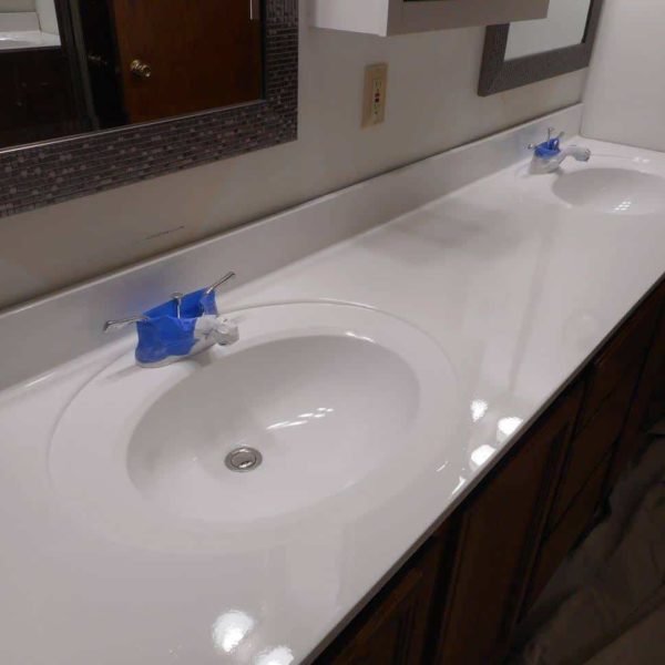 Double sink cultured marble vanity top after refinishing in high gloss Kohler white in Naperville, IL.